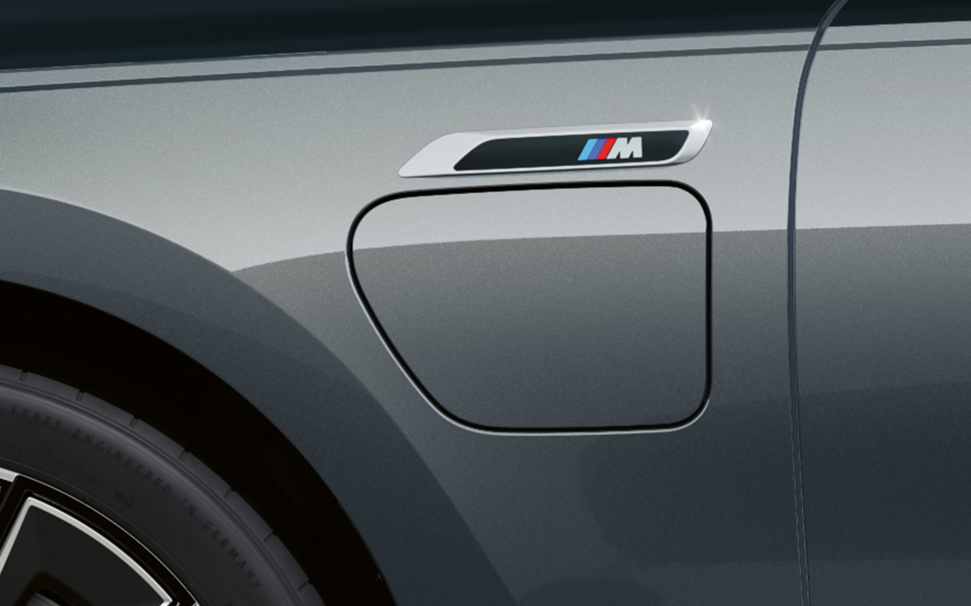 M oznaka BMW M760e xDrive Sedan G70 M Performance paket BMW Individual Black Sapphire metalik boja karoserije u dve nijanse BMW Individual Dravite siva metalik boja bliži bočni prikaz