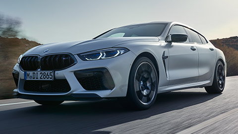 BMW M8 Gran Coupé (F93) three-quarter side view standing with model